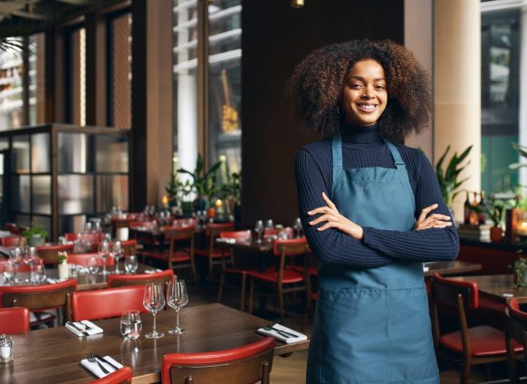 Cheerful small business owner in restaurant